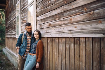 couple near old wooden house