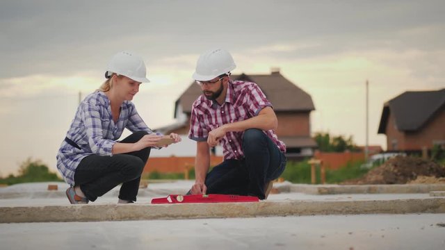 The quality control inspector photographs the readings of the device on the construction site. Quality construction without defects