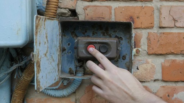 The old switchboard. Hand pushed switch on old electrical unit.
