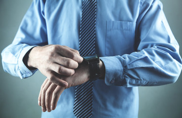 Obraz premium Businessman adjusting his wristwatch. Business concept