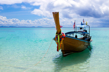 Amazing view of beautiful beach with traditional thailand longtale boat location bamboo island.