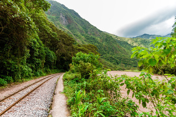 Fototapeta na wymiar Railroad tracks to Machu Picchu along the Vilcanota River (Urubamba) in Peru