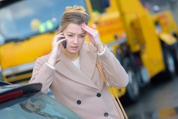 Stressed woman broken down and using telephone