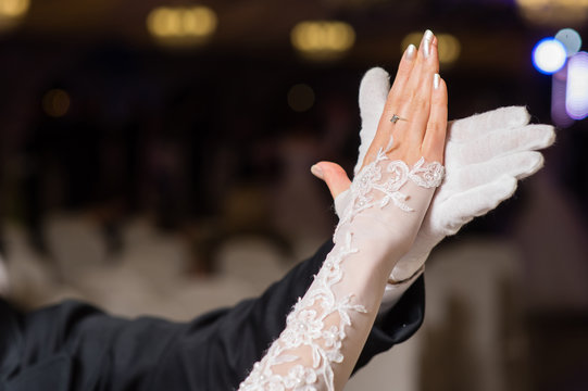 Hands of dancing waltz couple