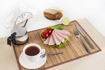 Sausage boiled with greens, tomatoes and cucumbers. Served with black or white bread. This is a good breakfast at the beginning of the day.