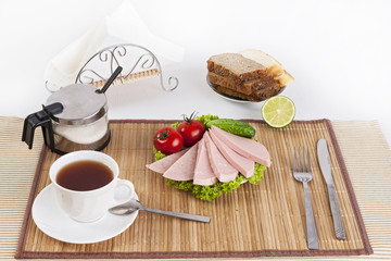 Sausage boiled with greens, tomatoes and cucumbers. Served with black or white bread. This is a good breakfast at the beginning of the day.