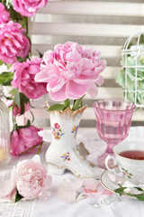 fresh peony flower in shoe shaped porcelain vase