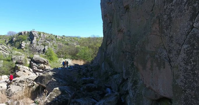 Aerial view. Group of tourists deep canyon among the rocks. Mountain landscape