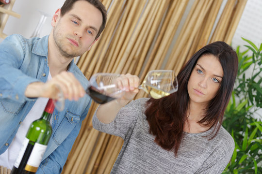 couple is wine tasting on couch