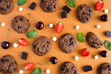 Flat lay,top view chocolate cookies with fruit on the light brown  background