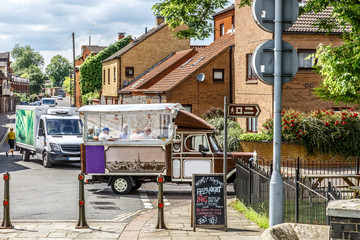 View of a small classic van by a typical English street.