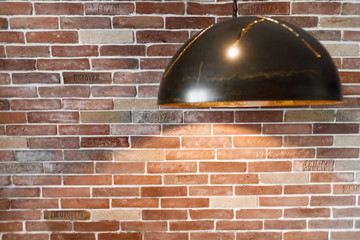 Old red bricks wall with metal lamps.