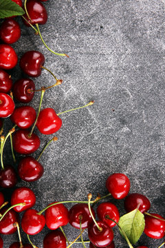 Cherry. Red fresh Cherries in bowl and a bunch of cherries on the table