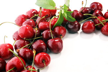 Cherry. Red fresh Cherries in bowl and a bunch of cherries on the table