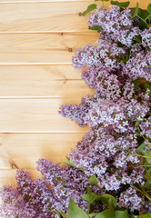 Fresh lilac flowers on wooden background. Selective focus.