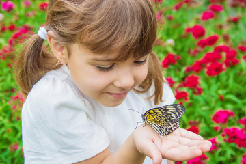 Child with a butterfly. Idea leuconoe. Selective focus. © yanadjan