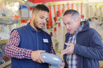 builders buying plastic pipes at a store
