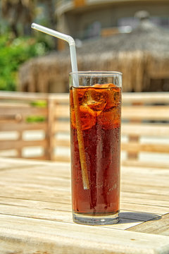 Glass of iced cola on the wood desk