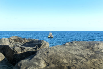 Fototapeta na wymiar Boat in the distance, near the horizon.