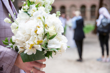 bride and groom holding wedding bouquet