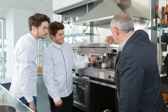 apprentices barmen training serving coffee with teacher