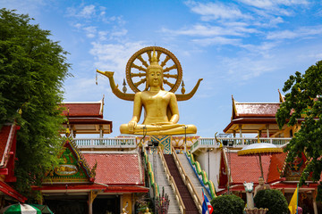 Big Buddha temple statue with staircase and colorful temples around, Koh Samui, Thailand