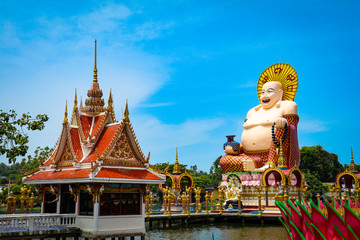 Wat Plai Laem temple with fat laughing Buddha statue and a smaller temple structure, Koh Samui, Thailand