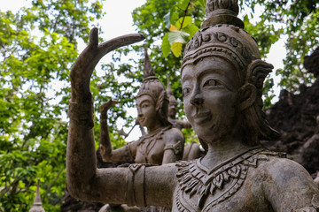 Fototapeta na wymiar Ancient stone Buddhist statues in Koh Samui Magic Garden, Thailand