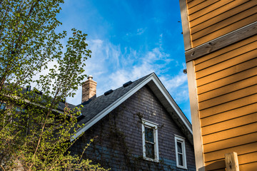 View of side of house and roof with blue skies