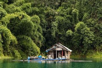 Fototapeta na wymiar Old wooden floating hut on a lake in Khao Sok, Thailand