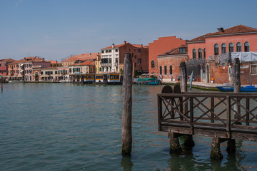 Obraz premium Island Murano in Venice Italy. View on canal with boat and motorboat water. Picturesque landscape. Traditional view of The Venetian canals