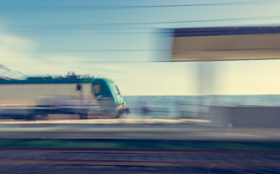 Blurred image of train passing through station.