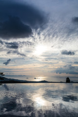 View of the ocean and nearby islands with a swimming pool in the foreground before sunset, Koh Samui, Thailand