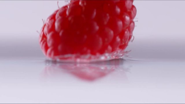 Super slow motion of falling raspberry into water. Filmed on cinema slow motion camera, 1000fps, ProRes 422 HQ codec.