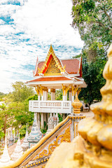 Thai traditional golden decorated Buddhism pagoda temple during a bright sunny day in Koh Samui, Surat Thani, Thailand 