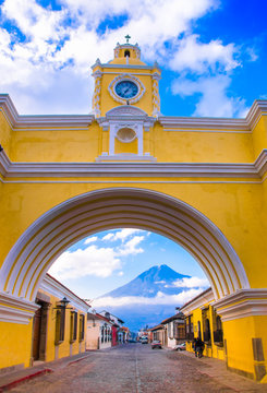 ANTIGUA, GUATEMALA - MARCH 25 2013: The famous arch of the city center of Antigua together with tourists and vendors of arts and crafts.