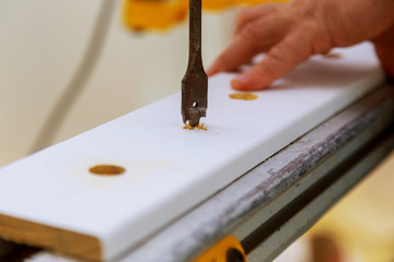 Drilling hole in wood, woodworking concept , drilling part of carpenter work.