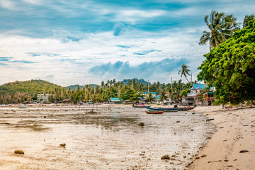 Small fisherman village on a sandy shore during a bright sunny day in Koh Samui, Surat Thani, Thailand 