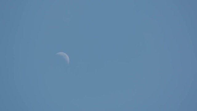 A daytime timelapse of the crescent moon (waxing) rising through the frame and leaving the top of the frame.