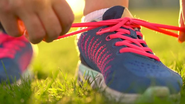 Running shoes - woman tying shoe laces