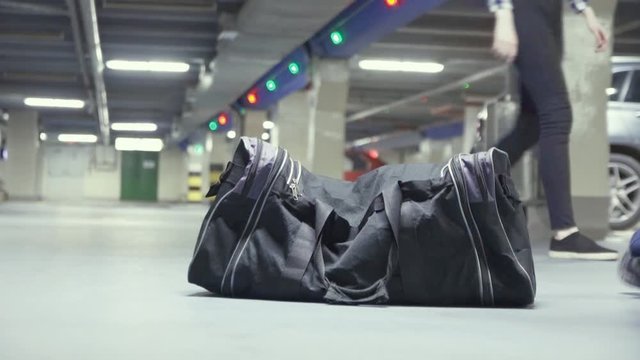 Forgotten suspicious black bag in the underground parking