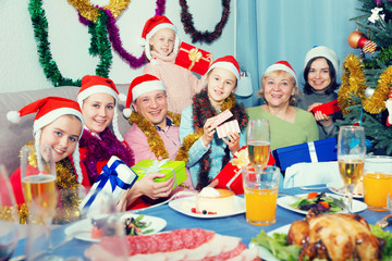 Family is posing with gifts in time celebration New Year