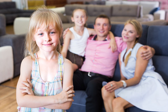 Young girl 8-12 years old is happyning of new sofa
