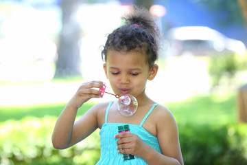 little girl launches soap bubbles