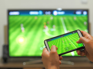 Playing soccer on a TV with a smartphone