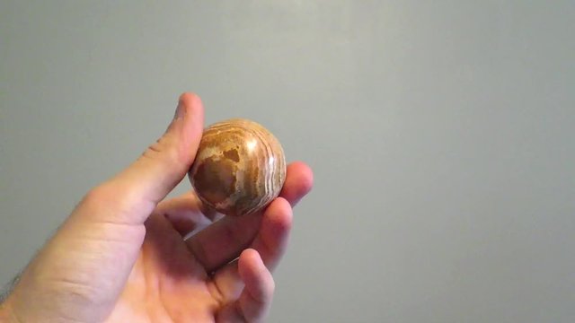 Hand showing aragonite star cluster.