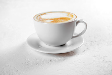 Cup of cappuccino coffee on white background - obrazy, fototapety, plakaty