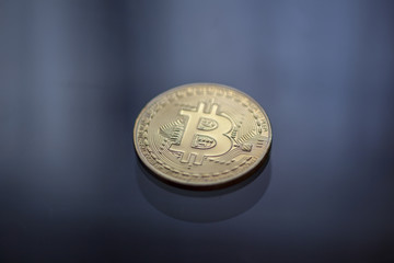 Bitcoin curency DOF on blue light background
