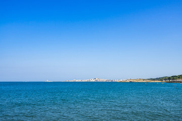 Summer seascape with the town of Vieste on the background, Gargano peninsula, Apulia, Italy