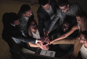 Fototapeta premium close up.young colleagues joined together their hands